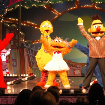 Elmo, Big Bird, and Bert from Sesame Street during a live show.